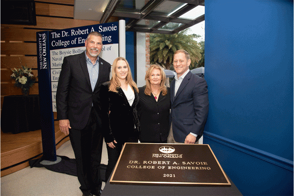 TK体育 President John Nicklow, Mallory Savoie, Dr. Bobby Savoie and Lori Savoie celebrate the naming of the Dr. Robert A. Savoie College of Engineering at an on-campus event on Tuesday, Dec. 14.