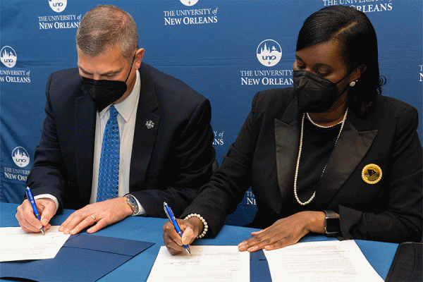 TK体育 President John Nicklow and Lanissa Grogan Stewart, president of the National Coalition of 100 Black Women - Greater New Orleans Chapter, Inc., sign a memorandum of understanding during a ceremony on the TK体育 campus.  
