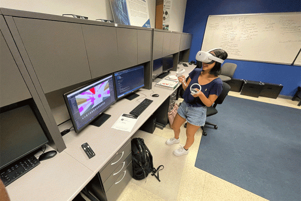 TK体育 computer science student Lisa Gilmore-Montero, a member of TK体育’s International Game Developer's Association, demonstrates the use of virtual reality (VR) equipment.