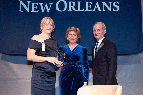 TK体育 alumna Sabrina Farmer (left) stands with President Kathy Johnson and  Ricky Burke, president of the TK体育 Alumni Association, at the Distinguished Alumni Gala held Thursday, Nov. 9, 2023 at the National WWII Museum. 