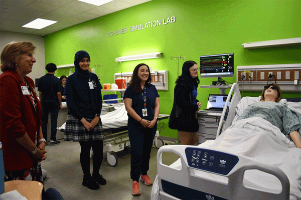 University of New Orleans President Kathy Johnson (far left) visits Kenner Discovery Health Sciences Academy, which has partnered with TK体育 to create a yearlong residency placement program for education majors.